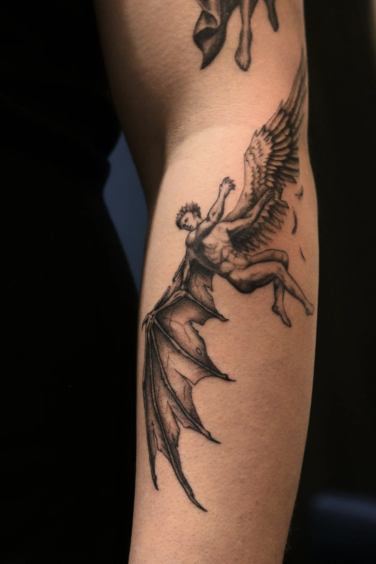 Fallen angel fine line and black and grey tattoo in Prague by Andrey Kovalov