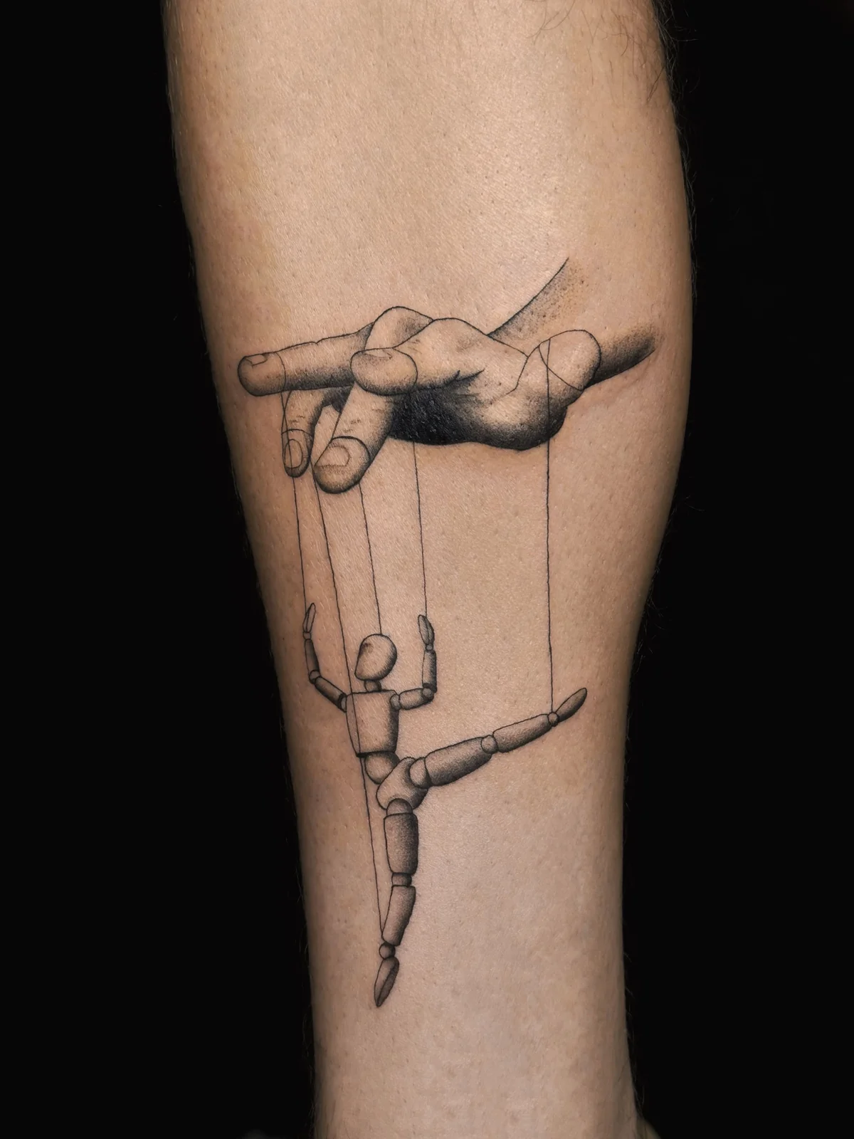 Marionette and hand graphic tattoo in Prague by Andrey Kovalov